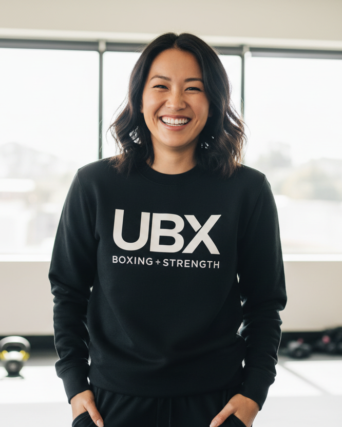 Black sweatshirt with 'UBX Boxing + Strength' text on a white background