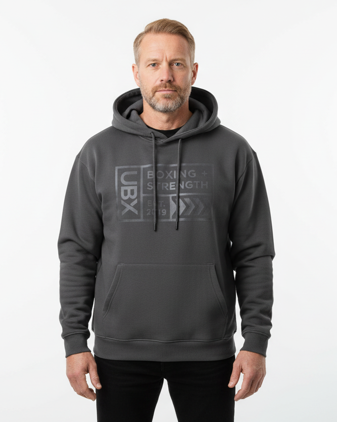 UBX Baseline Fleece Hoodie Dark on Dark Dark Gray — worn front view male model close-up