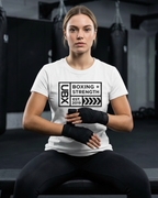 UBX Baseline Women's Bodycon T-Shirt Dark Print White — worn seated in boxing gym with hand wraps