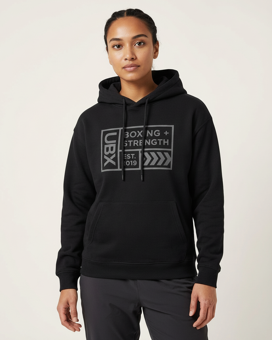 UBX Baseline Fleece Hoodie Dark on Dark Black — worn front view female model in studio