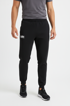 UBX Classic Joggers Black — worn with grey t-shirt and sneakers male model standing